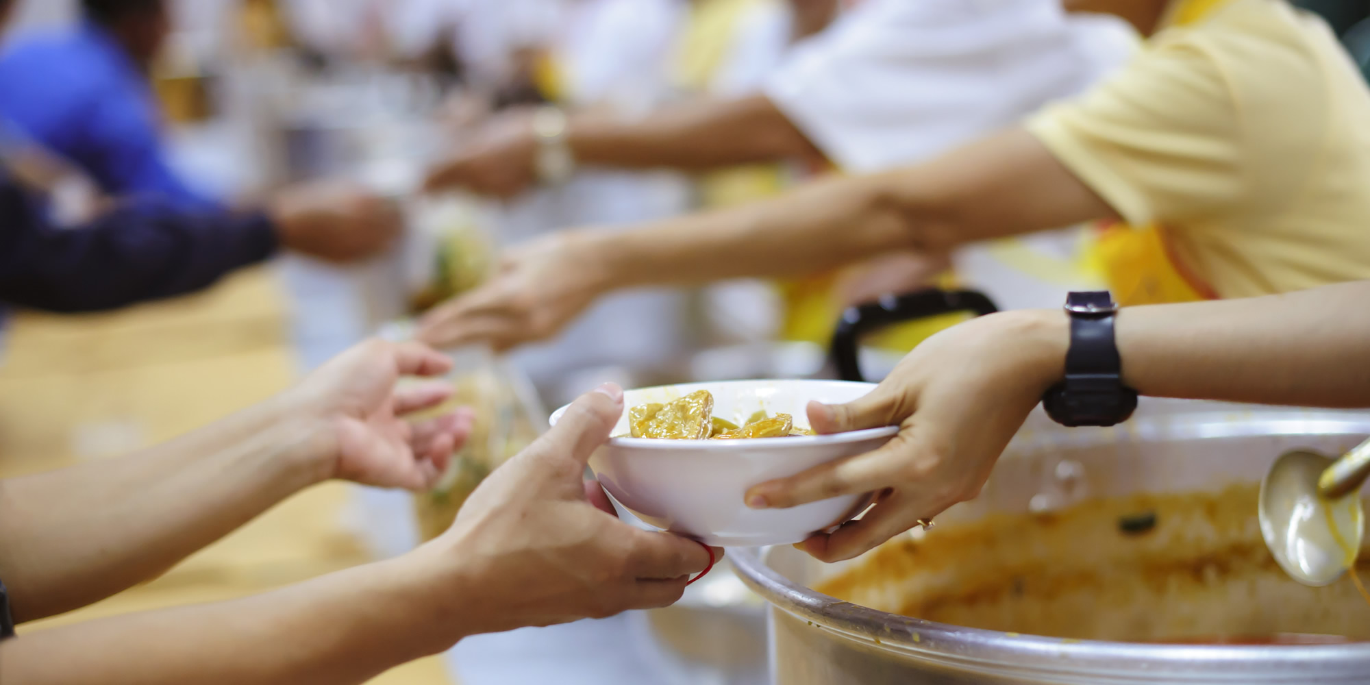Service Hero Image (volunteer hands serving meals)